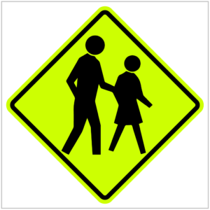 W6-1-01 - Yellow and black pedestrian crossing sign featuring a man and woman walking across the street produced by ASAP Signs