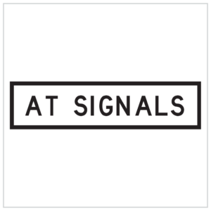 GM9-92B – AT SIGNALS SIGN IN A BOLD BLACK LETTERING ON A WHITE BACKGROUND